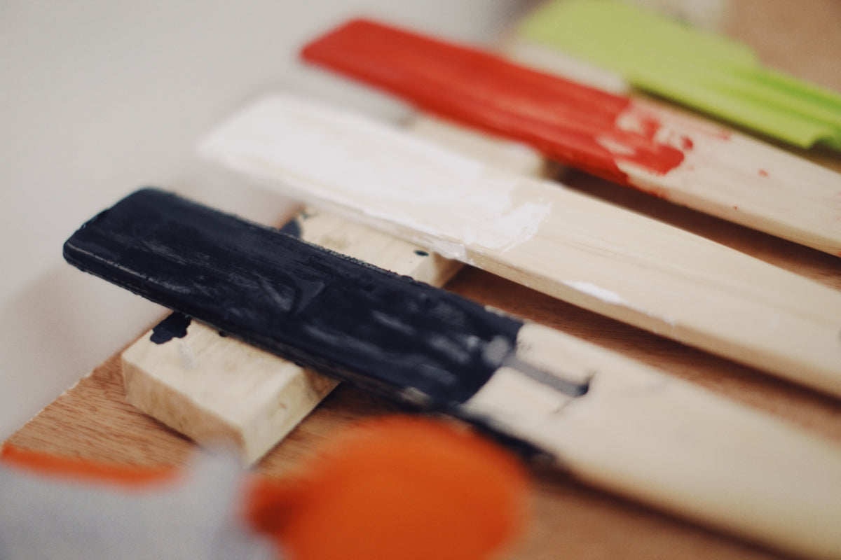 a close up of a group of different colored toothbrushes