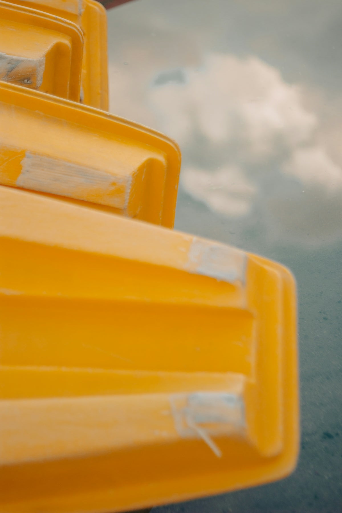 a close up of a yellow object with a sky in the background
