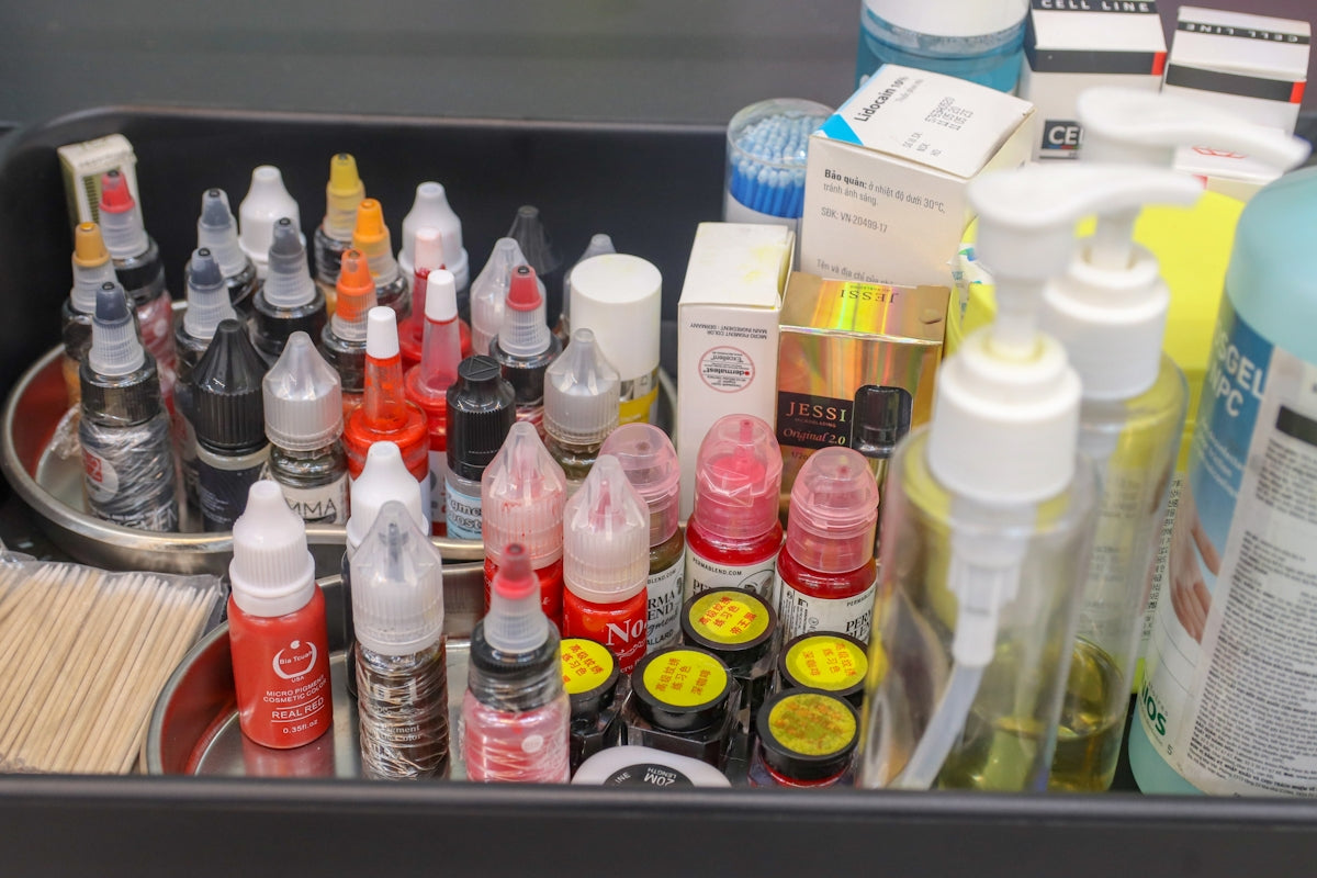 A metal container filled with lots of different types of paint