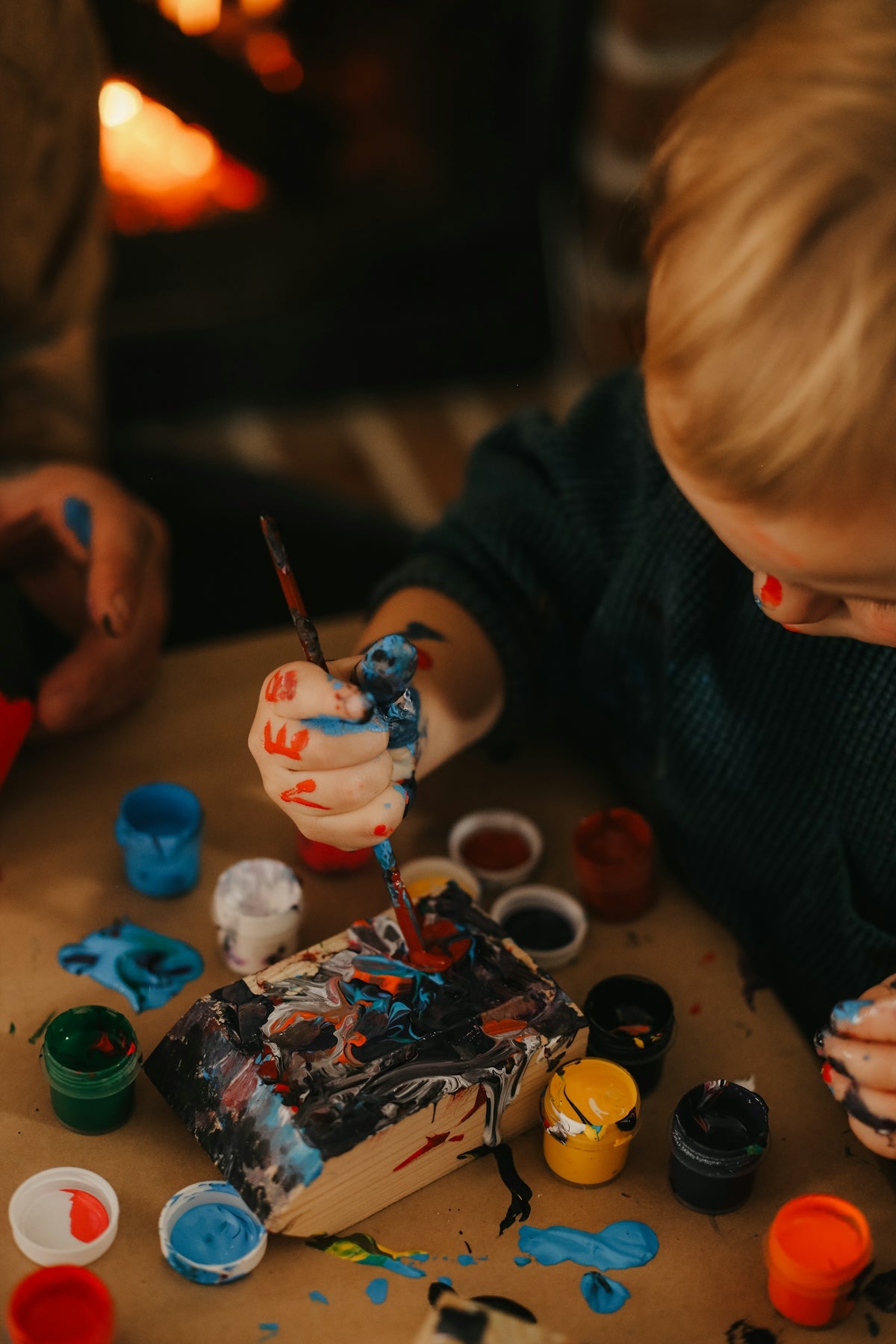 a child painting on a table