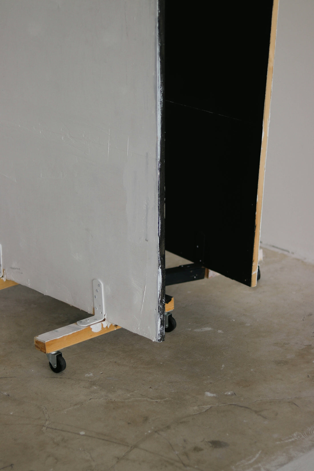 a black door next to a white wall