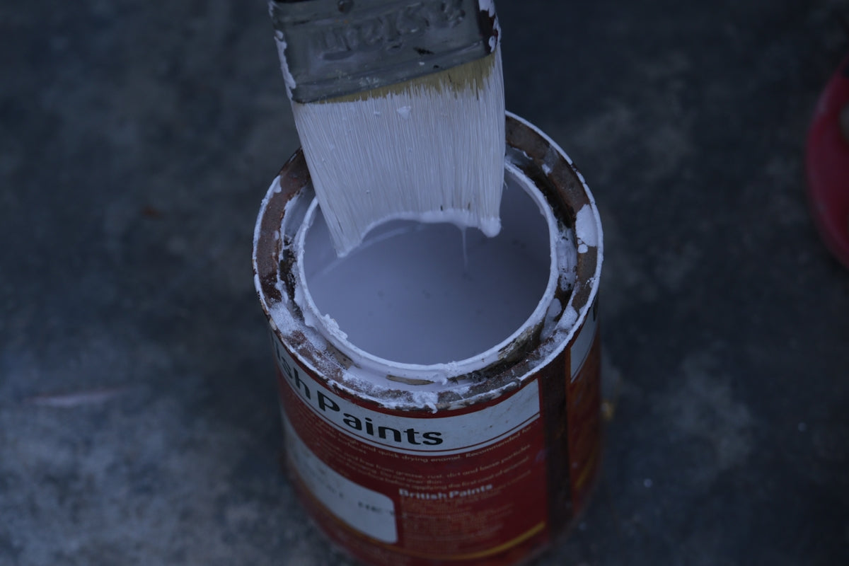 a paint can with a brush inside of it
