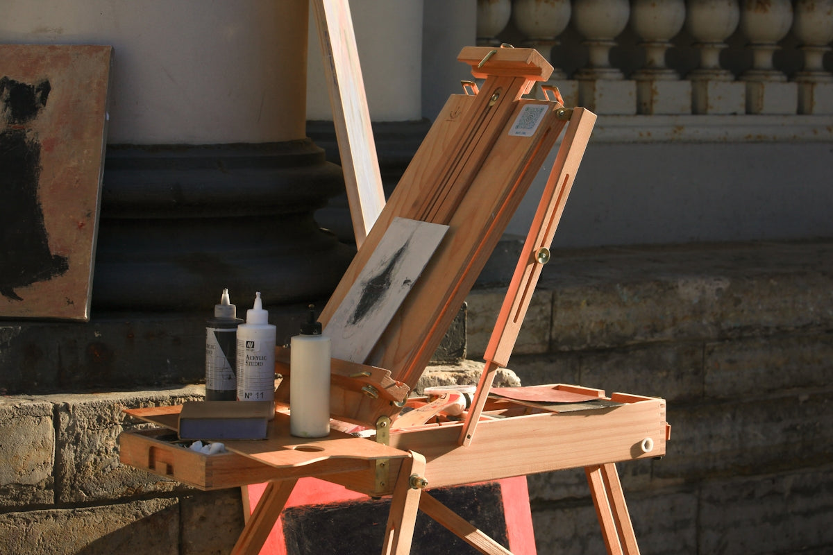 A wooden easel with a painting on top of it